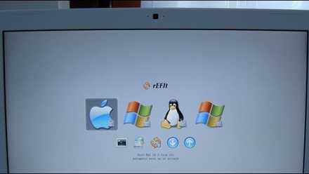 An image of a laptop with several OS logos on the screen.