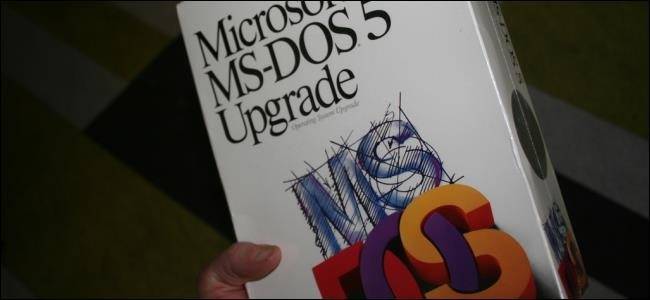 A hand holding an MS-DOS 5.0 upgrade box.