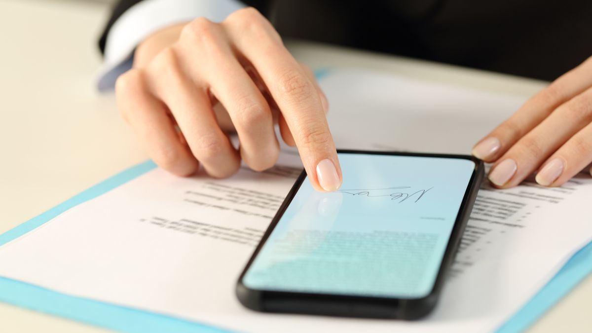 Person signing a document on their smartphone