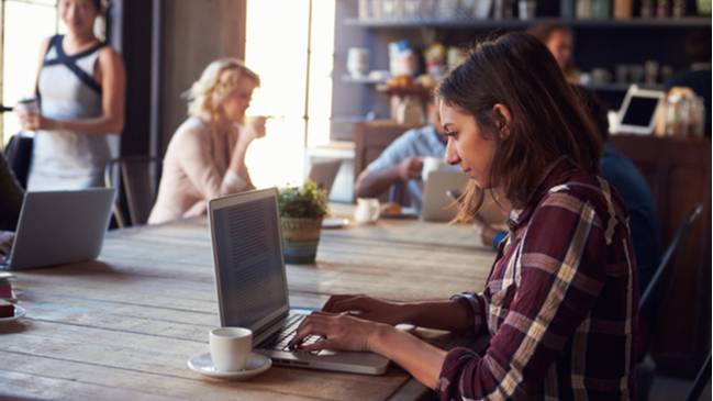 Man using laptop computer in cafe