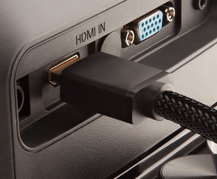 An HDMI cable plugged into the back of a TV