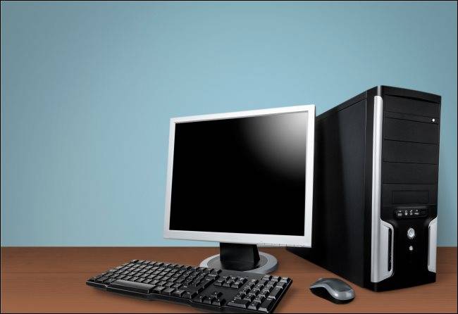 An office PC case, a instructor, a keyboard and a mouse on a table.