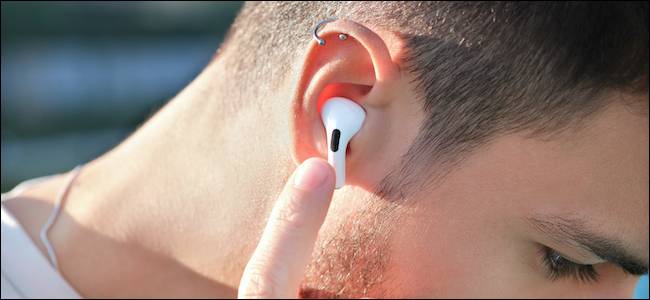 Person using touch controls on Apple AirPods Pro