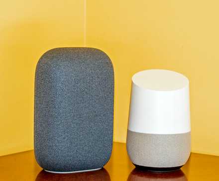 A Nest Audio next to a Google Home, showing it is skinner and taller than the Home.
