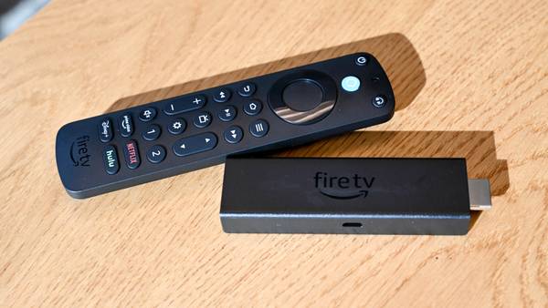 Amazon Alexa Voice Remote Pro sitting next to an Amazon Fire Stick