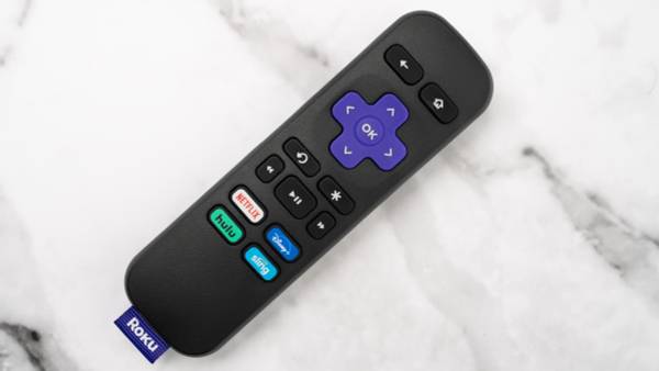 A Roku remote laying on a table