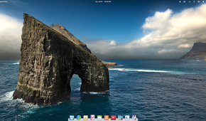 elementary OS 6 desktop with wallpaper featuring a horseshoe shaped rock in the sea.