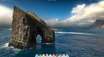 elementary OS 6 desktop with wallpaper featuring a horseshoe shaped rock in the sea.