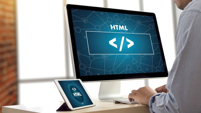 Closeup of computer and tablet screens showing HTML