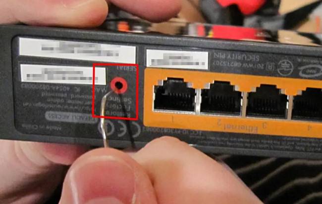 resetting router with paperclip in reset hole