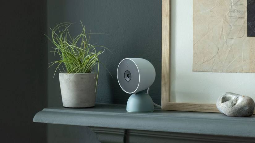 A Google Nest camera sitting on a mantle.