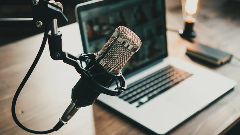 Home studio microphone in front of a laptop.