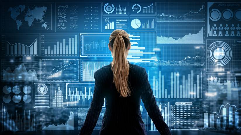 Image of woman looking at illustrations of various graphs and charts.