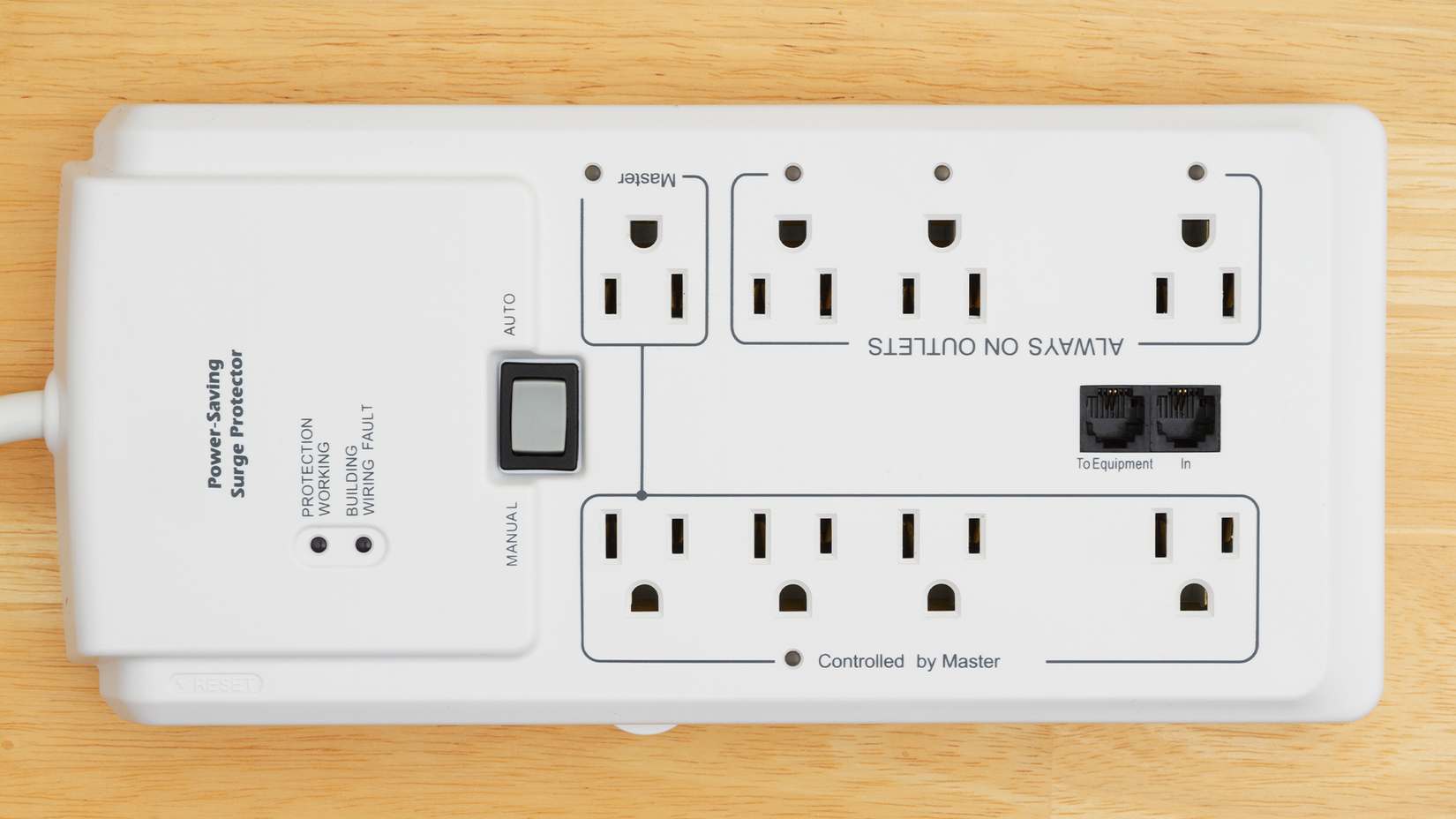 A big white surge protector on a wooden floor.