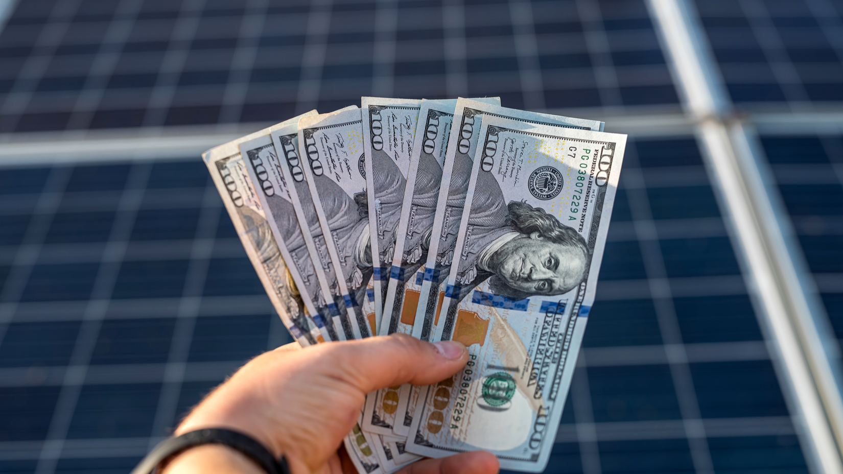 Solar panels and a pile of money