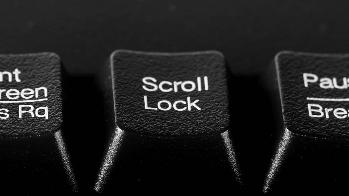 Closeup of the Scroll Lock button on a black computer keyboard.