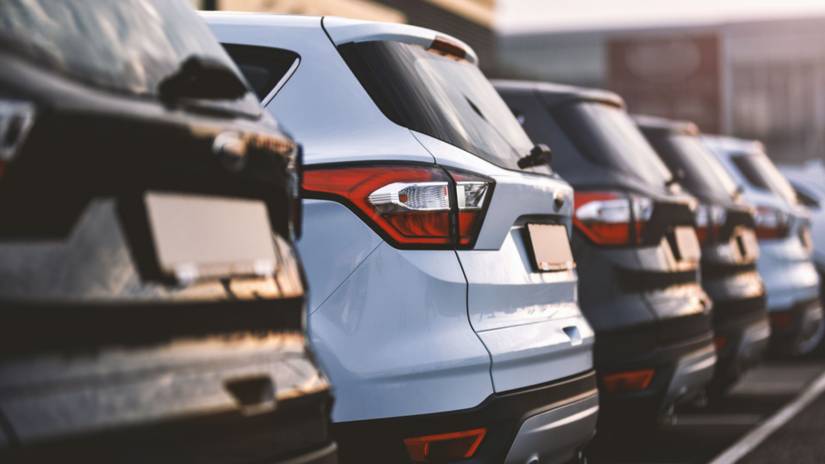Cars lined up in a parking lot.
