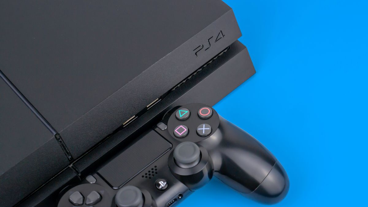 A Sony PS4 console with a DualShock controller next to it on a blue background.