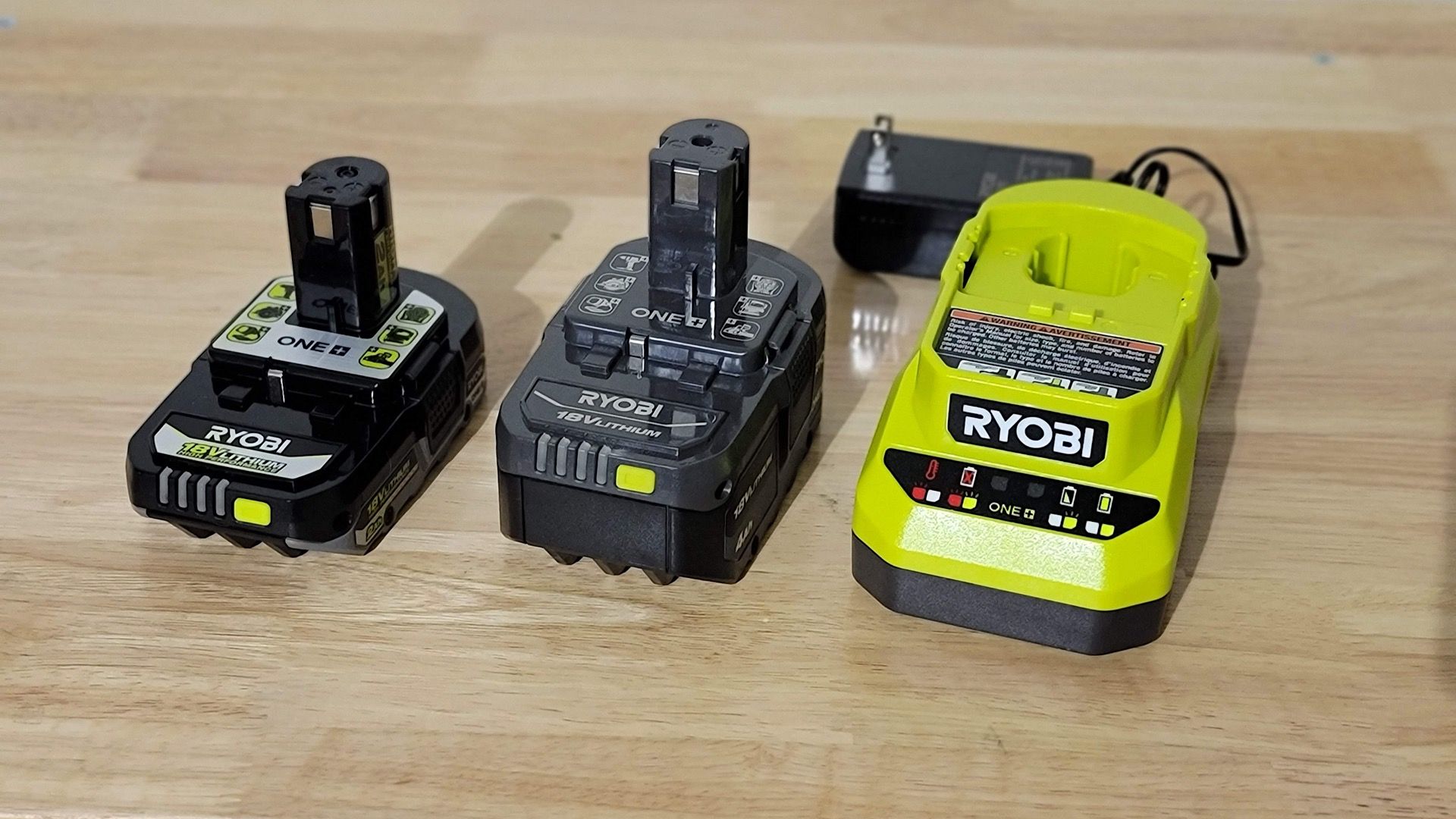 Ryobi battery and charger on a work bench. 