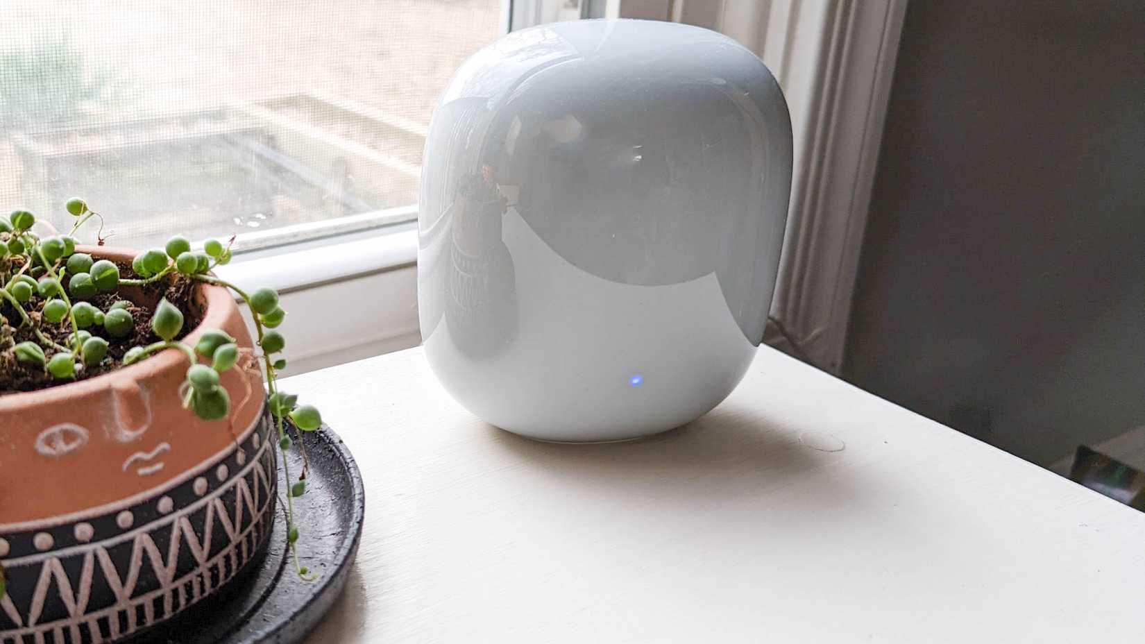 Nest Wifi Pro mesh router with the blue system update indicator light.