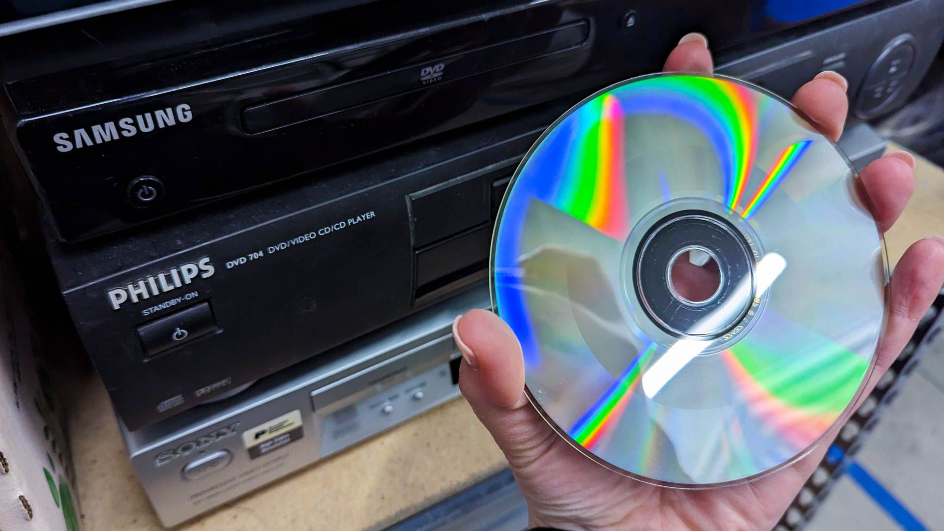 A hand holding a video cd.