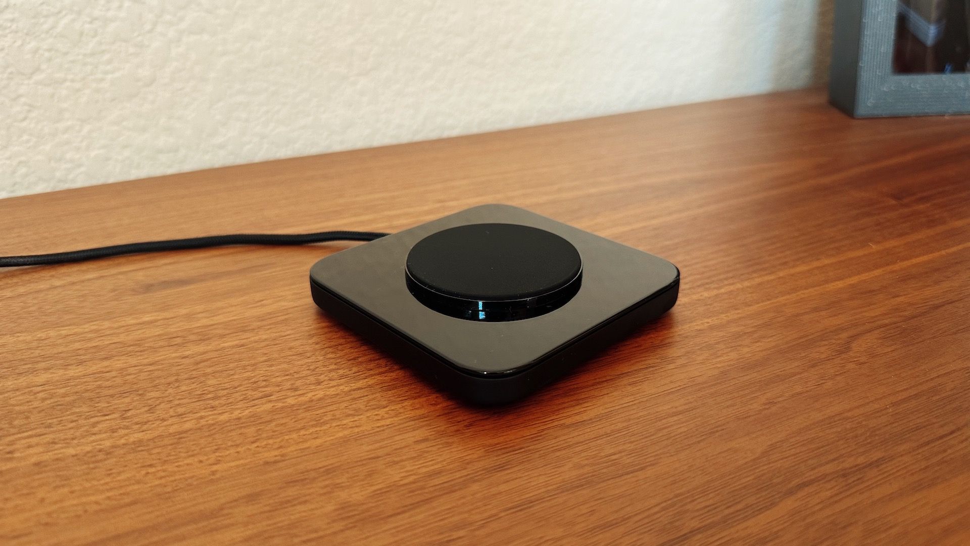 Showing the Nomad Base in black on a wood table