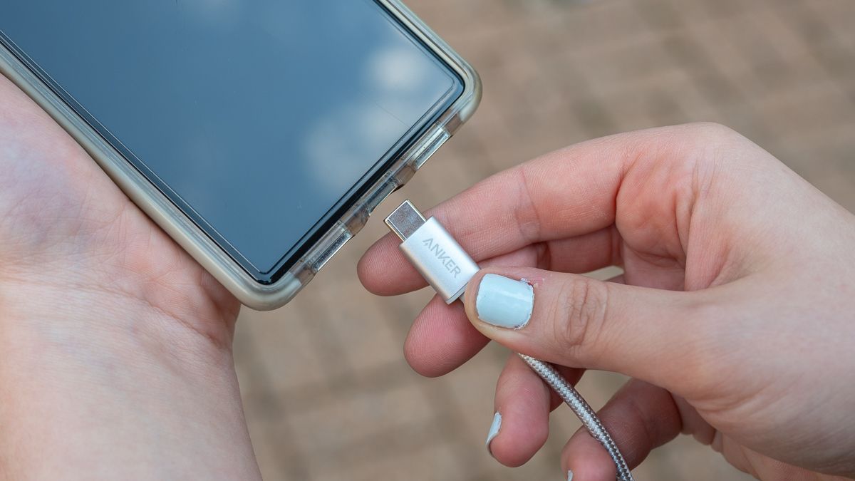 Person plugging in USB cable