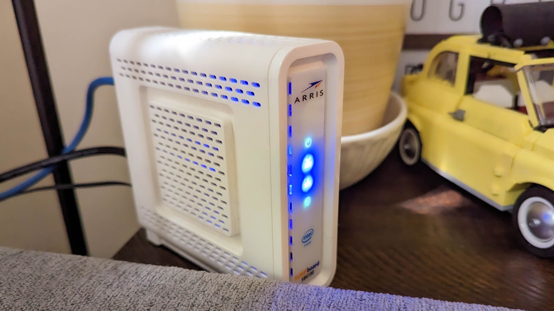 An Arris modem set up behind a couch