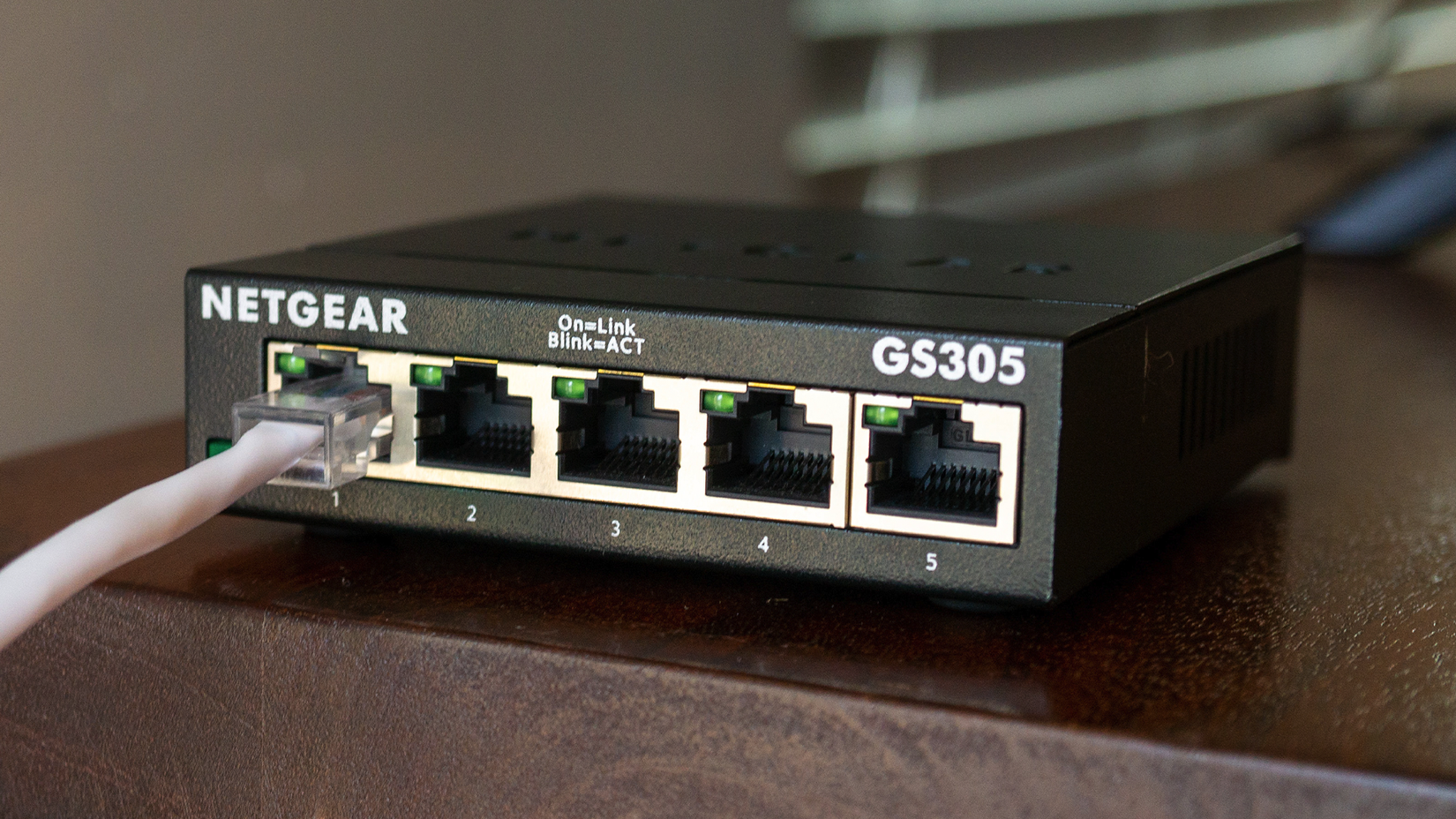A Netgear Network Switch with an Ethernet cable plugged in.