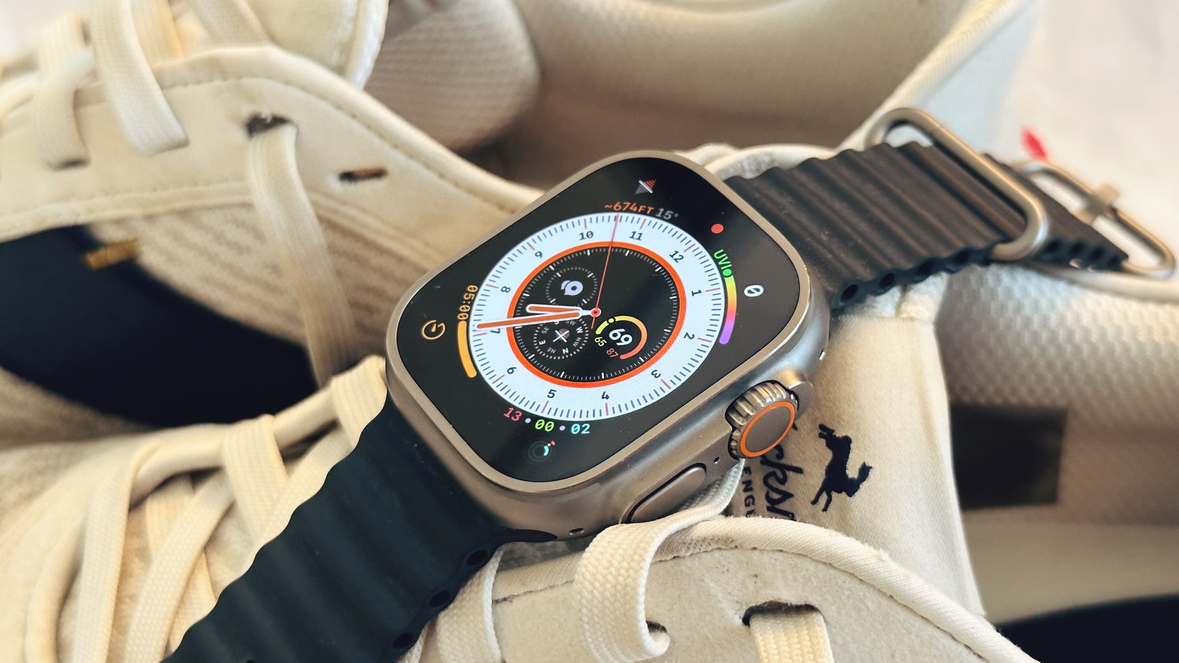 Apple Watch Ultra laying on top of running shoes