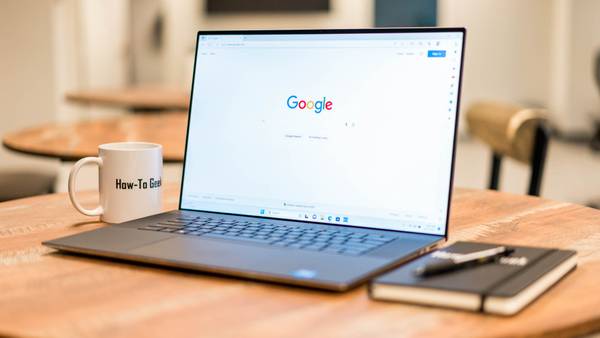 Dell XPS 17 set up on a table with a notebook.