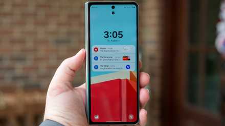 Person holding the Samsung Galaxy Z Fold 5 closed with the front display lock screen turned on