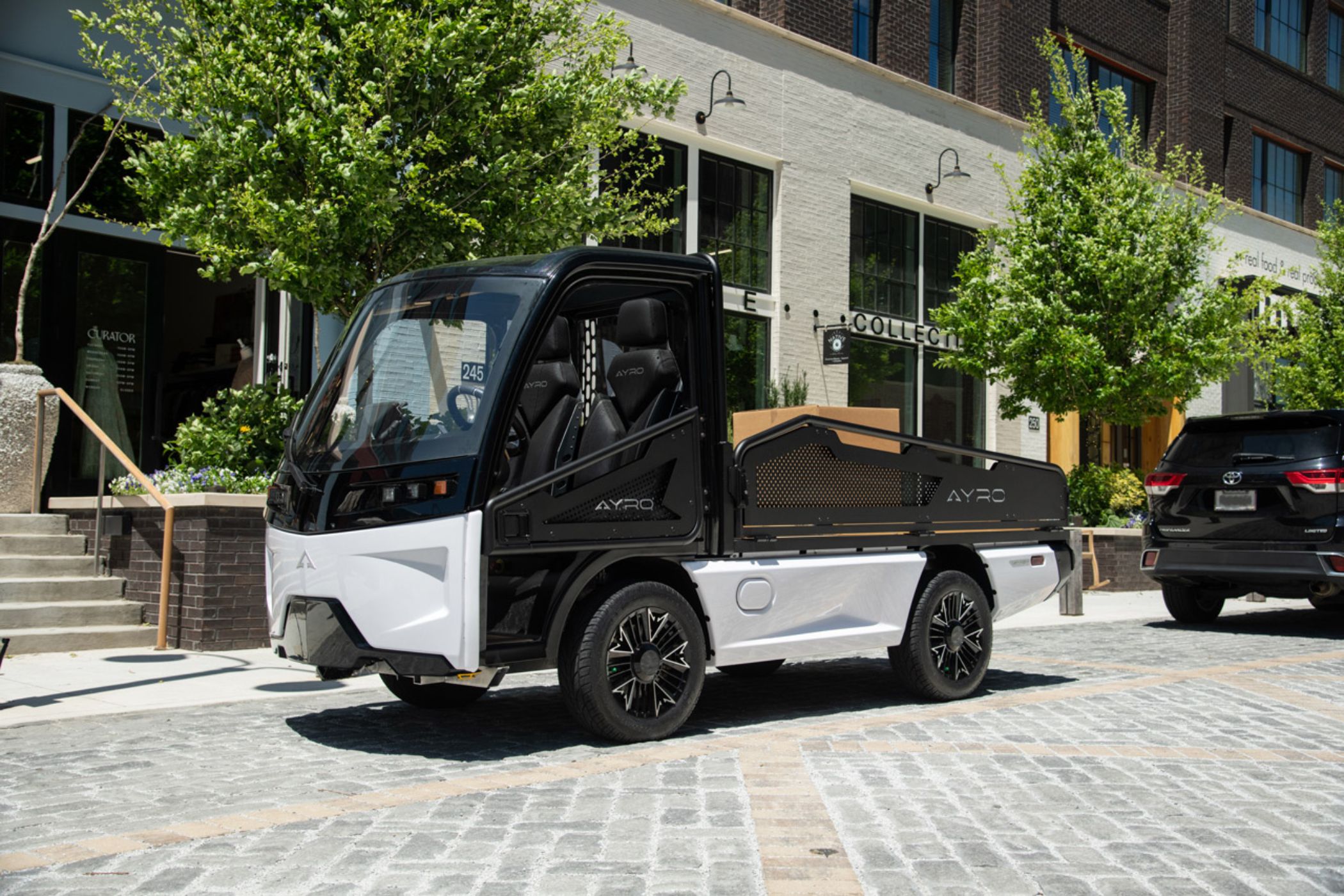 AYRO Vanish mini electric truck driving on the street. 