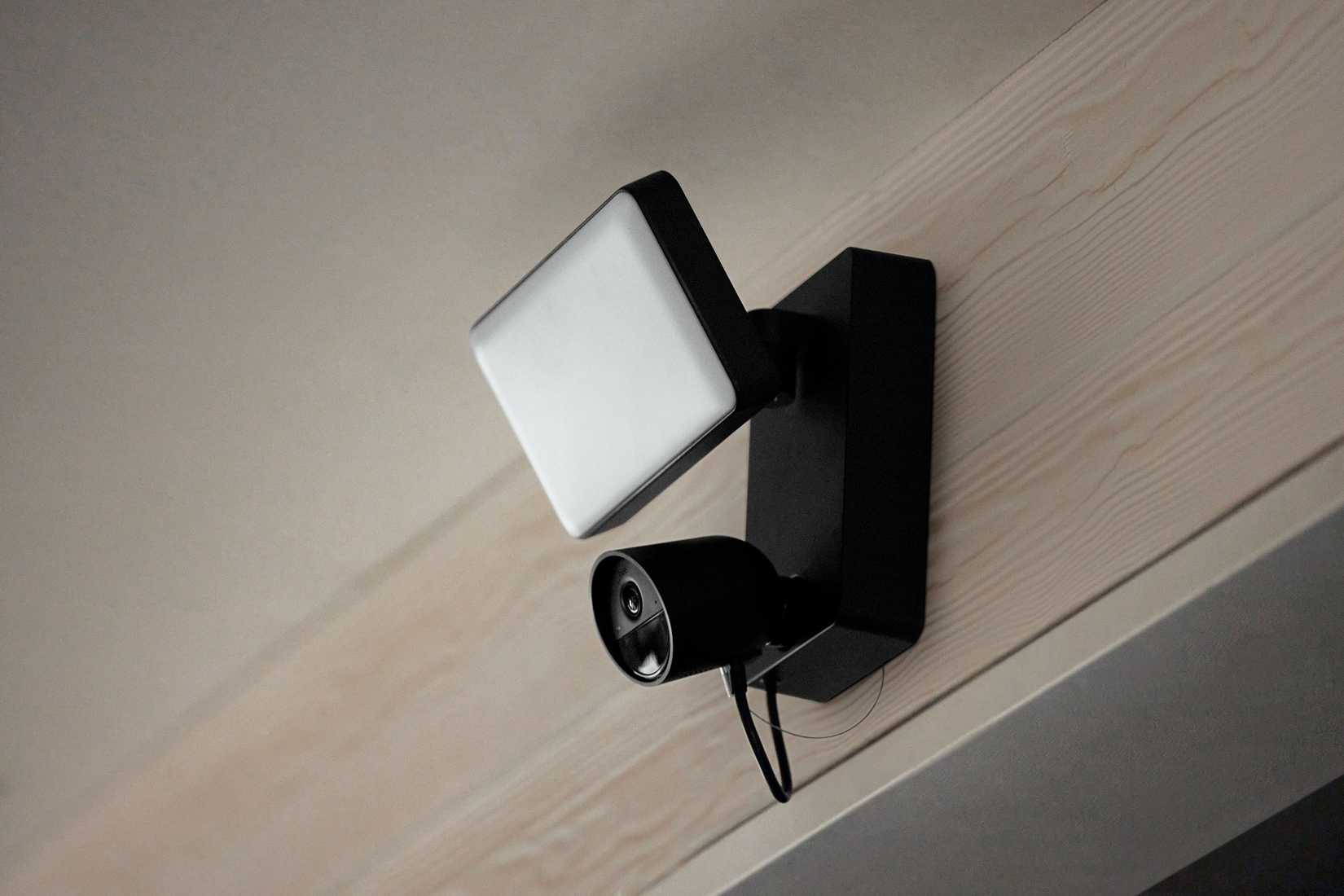 A Philips Hue Secure camera mounted on the outside of a home.