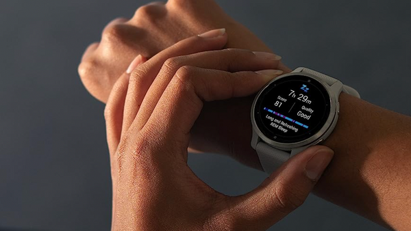 Closeup of a woman checking a Garmin Venu 2S smartwatch.