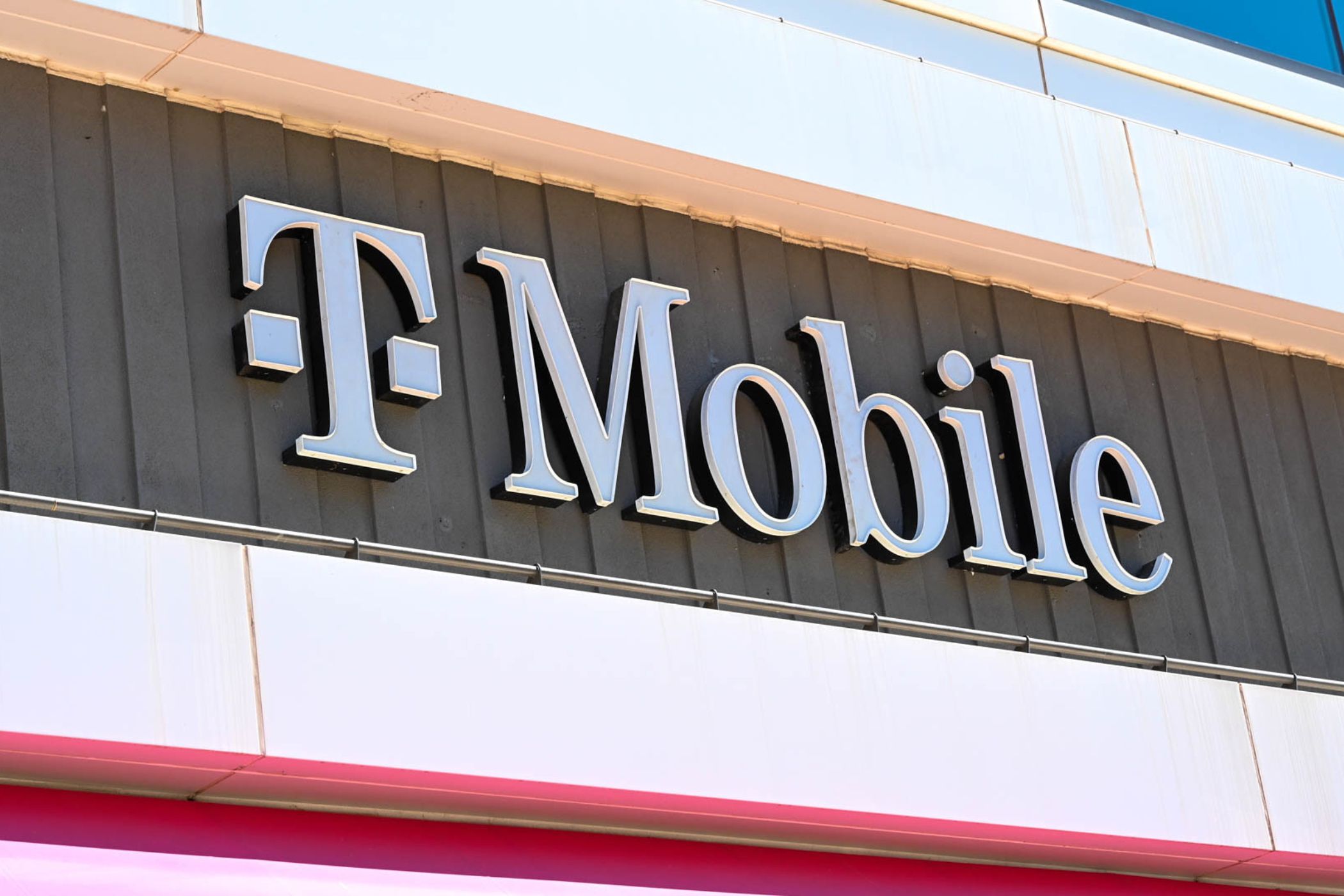 T-Mobile logo and storefront in a downtown area. 