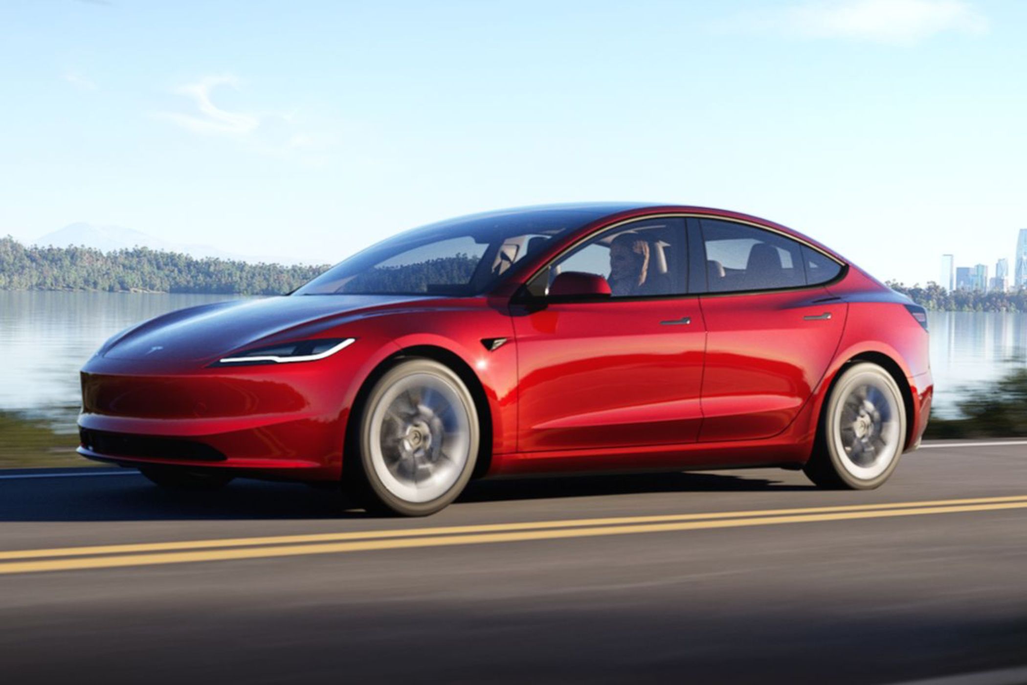 New 2024 Model 3 driving on a road. 