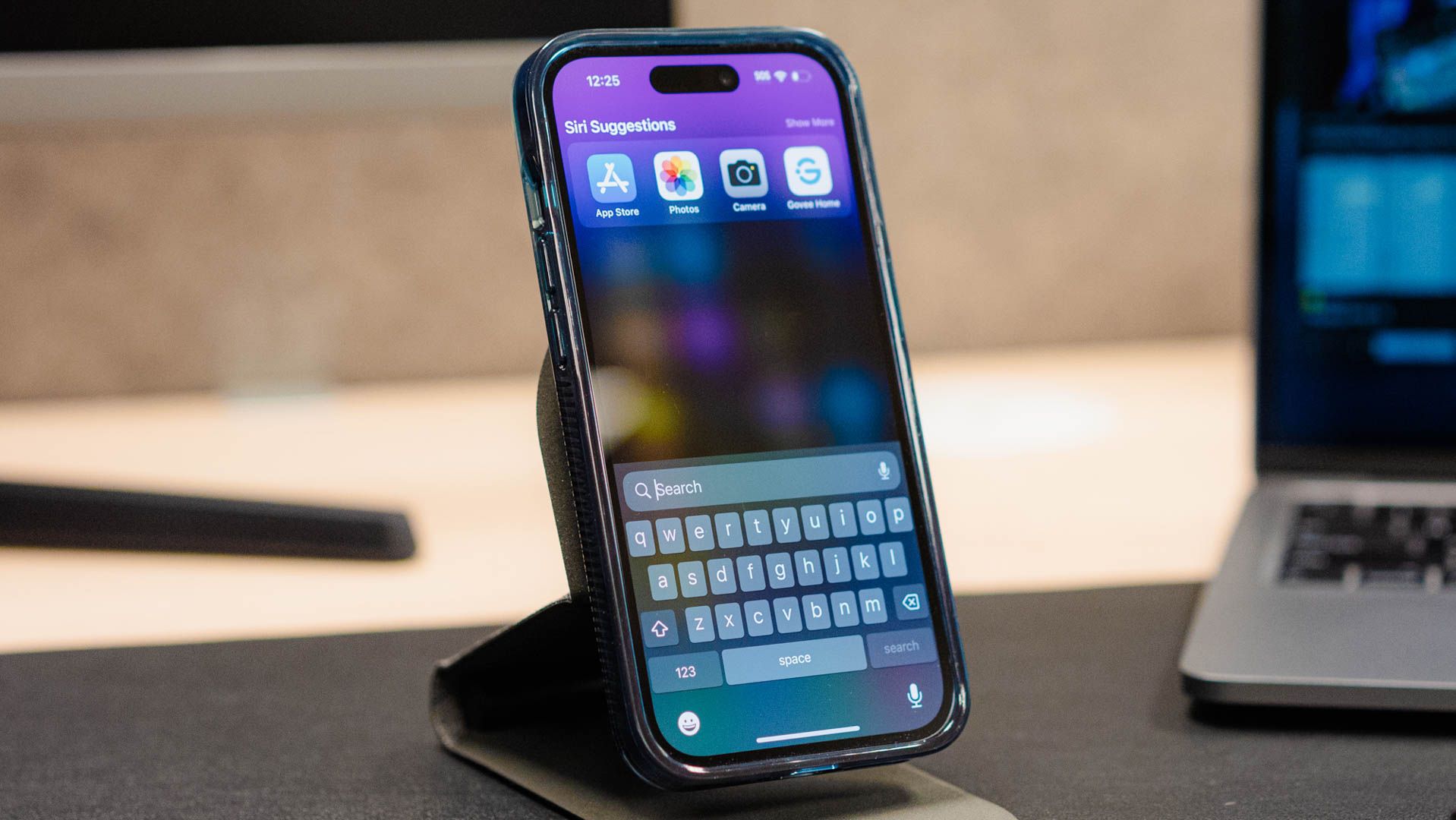 An iPhone keyboard on the Spotlight Search screen