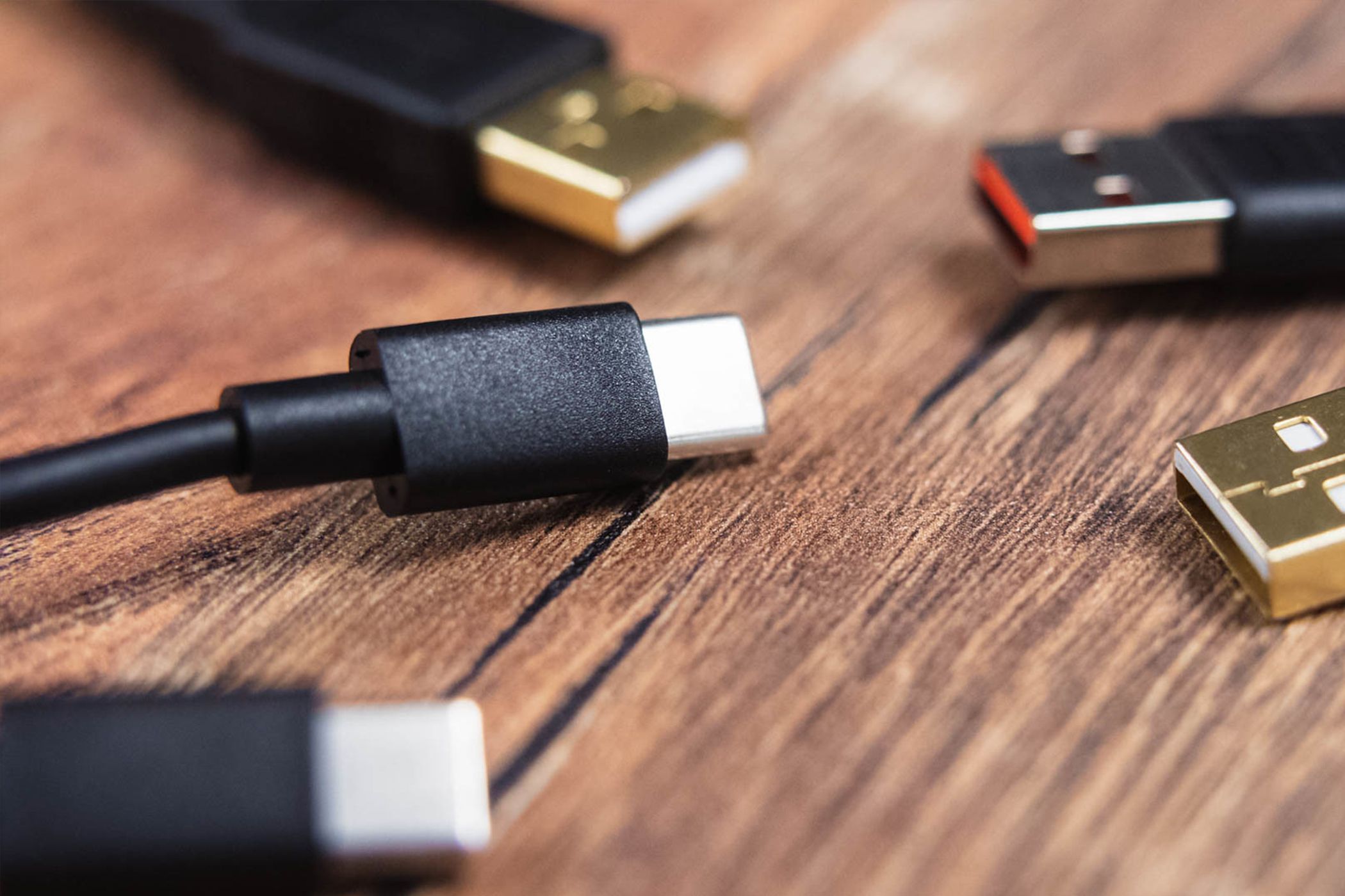 An assortment of USB cables on a table.