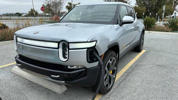 Rivian R1T truck at a charging station. 