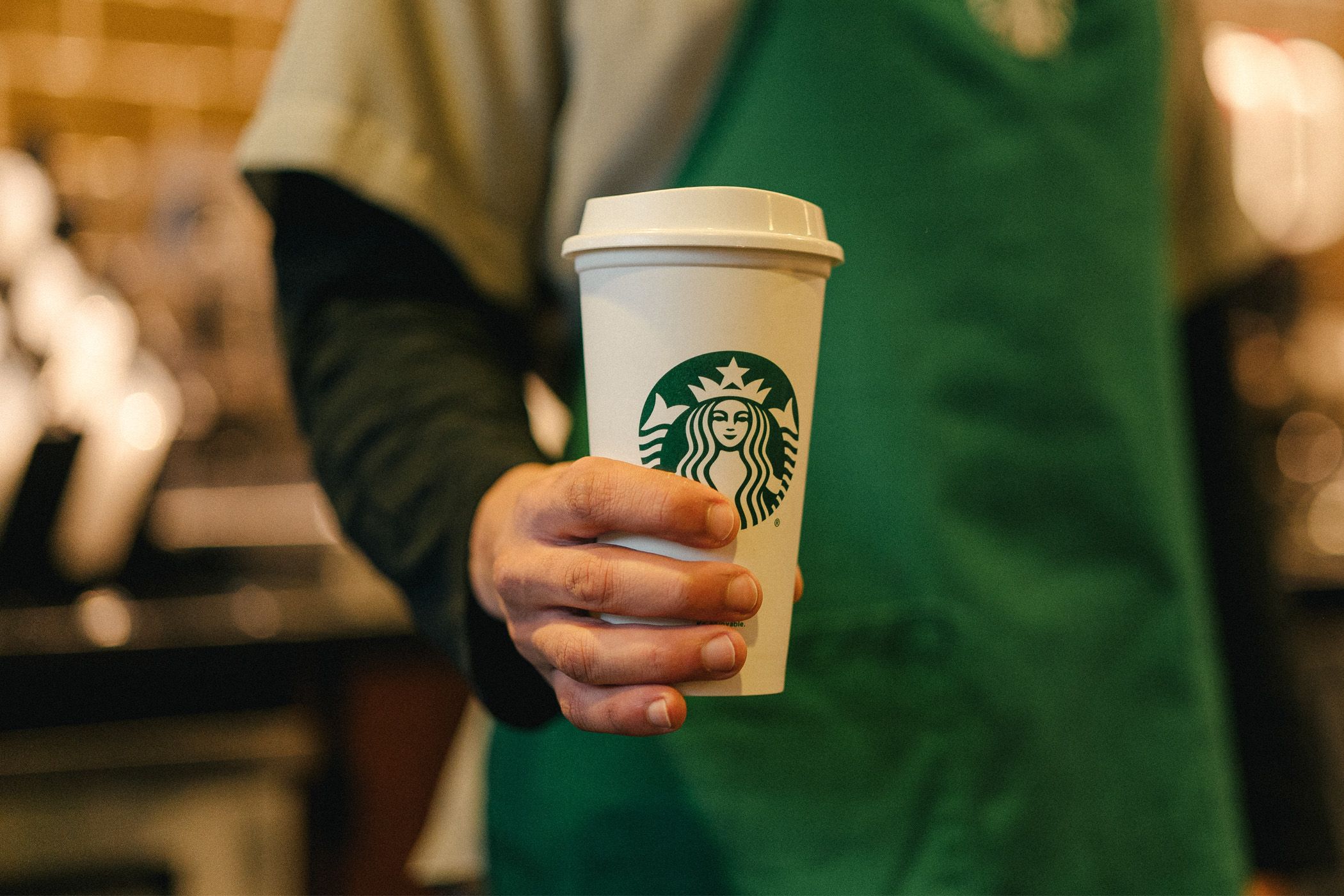 Person holding Starbucks cup