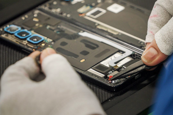 Repair technician working on a Samsung Galaxy foldable. 