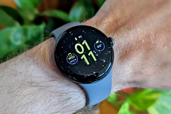 The Pixel Watch covered in water droplets.