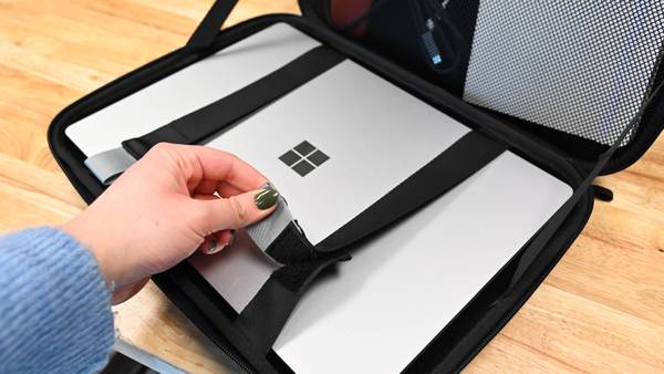 Person securing a laptop in the Pelican Ranger Series Laptop Case