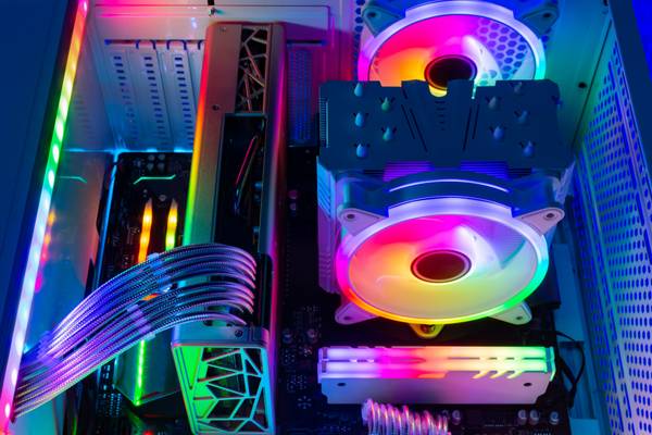  The inside of a white gaming computer with RGB fans, RAM, and an LED strip.