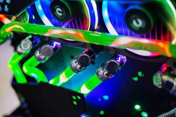 A close-up shot of a high-end gaming computer with neon green custom loop water cooling.