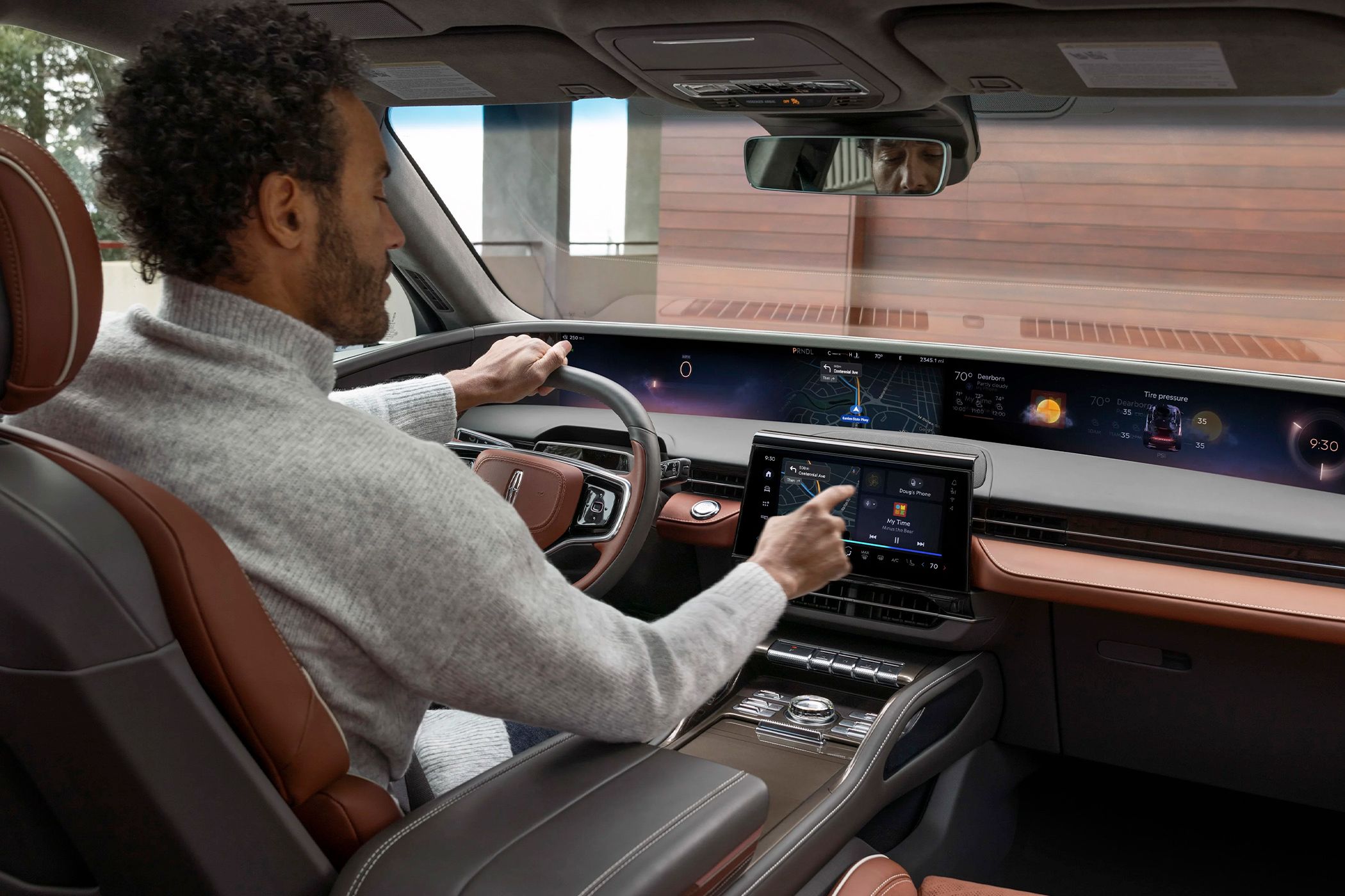 Someone testing Ford's new infotainment experience in a Lincoln Nautilus.