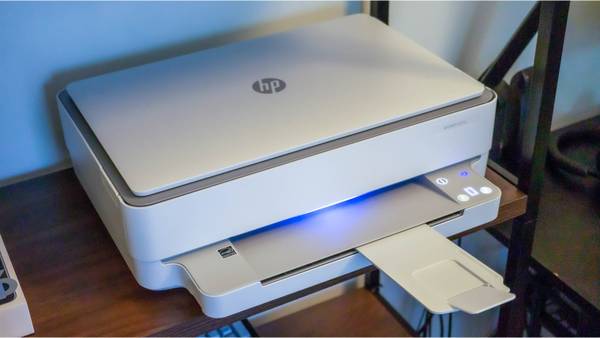 An HP printer on a desk. 