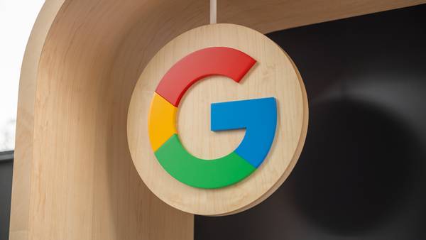 Google G logo on a wood sign at IO 2023. 