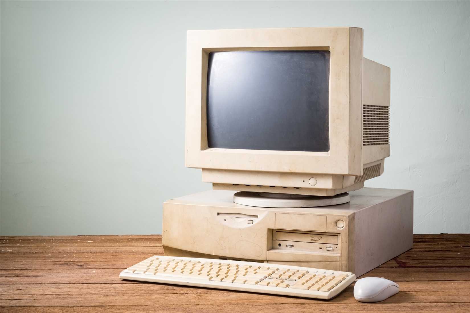 Old beige computer with a CRT screen. 